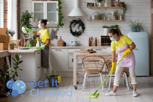 Cleaners with a mop doing move out cleaning
